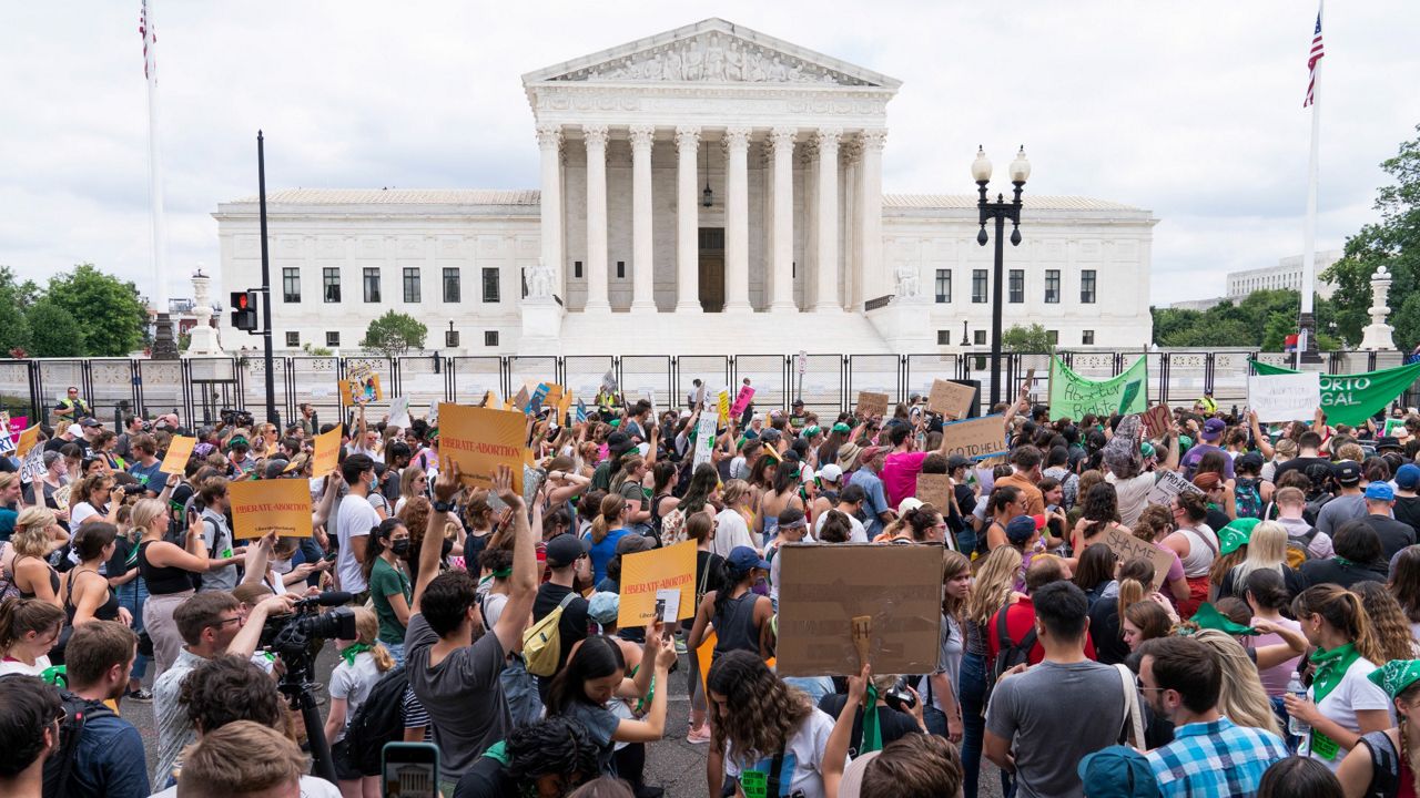 Protesters gather outside the Supreme Court in Washington on June 24. (AP Photo/Jacquelyn Martin, File)