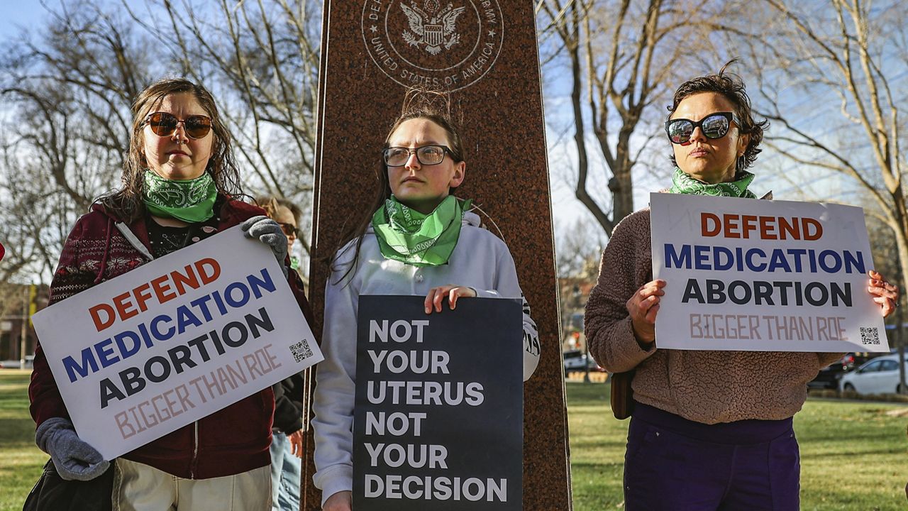 Three members of the Women's March group protest in support of access to abortion medication outside the Federal Courthouse on Wednesday, March 15, 2023 in Amarillo, Texas. Matthew Kacsmaryk, a Texas judge who sparked a legal firestorm with an unprecedented ruling halting approval of the nation's most common method of abortion, Friday, April 7, 2023, is a former attorney for a religious liberty legal group with a long history pushing conservative causes. (AP Photo/David Erickson)