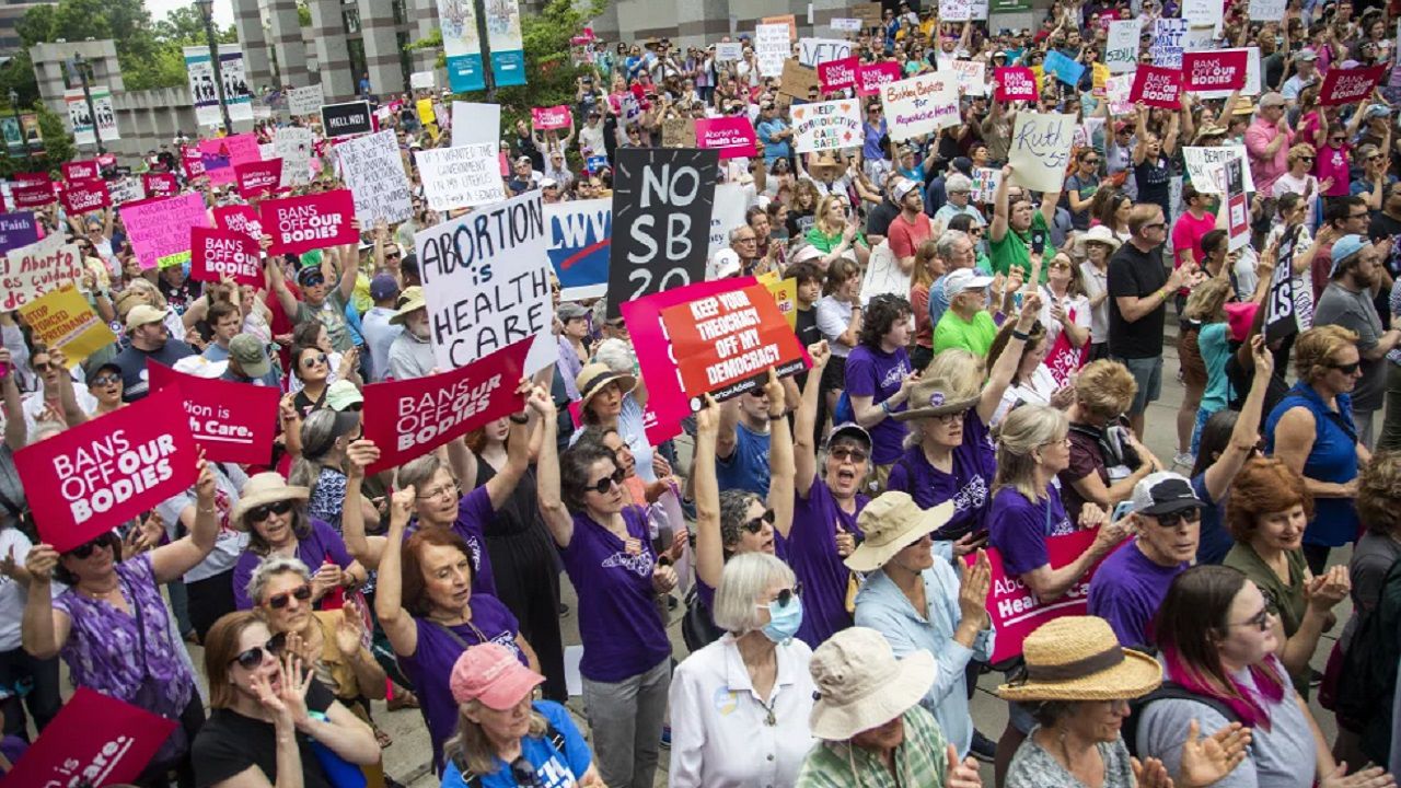 FILE - Hundreds of abortion ban veto supporters turned out to watch North Carolina Gov. Roy Cooper sign a veto of the on Bicentennial Mall in Raleigh Saturday, May 19, 2023. Abortion providers in North Carolina filed a federal lawsuit Friday, June 16, 2023, that challenges several provisions of a state law banning most abortions after 12 weeks of pregnancy in the dwindling days before the new restrictions take effect.(Travis Long/The News & Observer via AP, File)