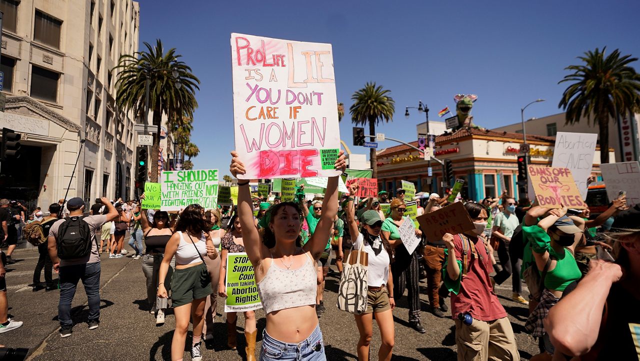 Abortion-rights activists rally on Hollywood Boulevard in Los Angeles, Saturday, July 9, 2022. Gov. Gavin Newsom signed more than a dozen new abortion laws on Tuesday, Sept. 27, 2022, including some that deliberately clash with restrictions in other states. (AP Photo/Damian Dovarganes, File)