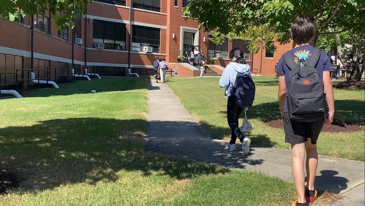 Students walking into Walter M. Williams High School for their first day