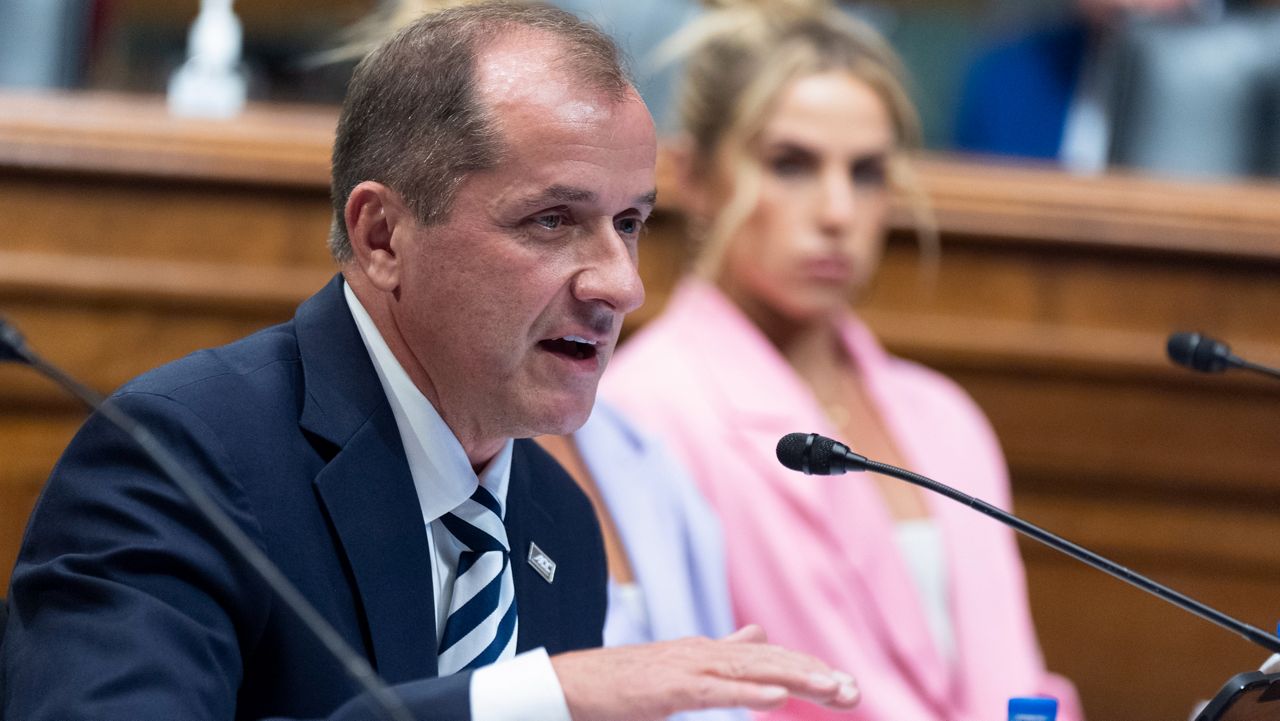 Atlantic Coast Conference Commissioner Jim Phillips, left, speaks as TCU student athlete Haley Cavinder listens during a roundtable on the future of college athletics on Capitol Hill on Tuesday, March 12, 2024, in Washington. (AP file photo/Manuel Balce Ceneta)