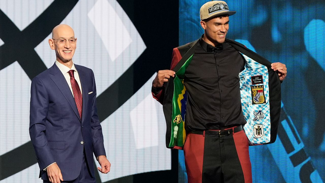 Tristan da Silva, right, reacts on stage with NBA commissioner Adam Silver after being selected as the 18th pick by the Orlando Magic during the first round of the NBA basketball draft, Wednesday, June 26, 2024, in New York. (AP Photo/Julia Nikhinson)