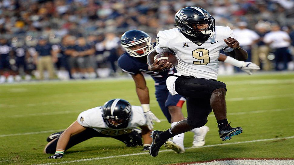 UCF running back Adrian Killins Jr. (9) runs the ball in for a touchdown during the first half of an NCAA college football game against Connecticut on Thursday, Aug. 30, 2018, in East Hartford, Conn. (AP Photo/Stephen Dunn)