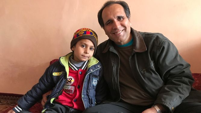 This photo provided by Bahaudin Mujtaba shows Noman Mujtaba, left, and Bahaudin Mujtaba in Kabul, Afghanistan, on Dec. 21, 2017. The boy, now 10 years old, is a distant relative of Mujtaba, who lives in Florida and is trying to adopt him and bring him to the United States. (Courtesy of Bahaudin Mujtaba via AP)