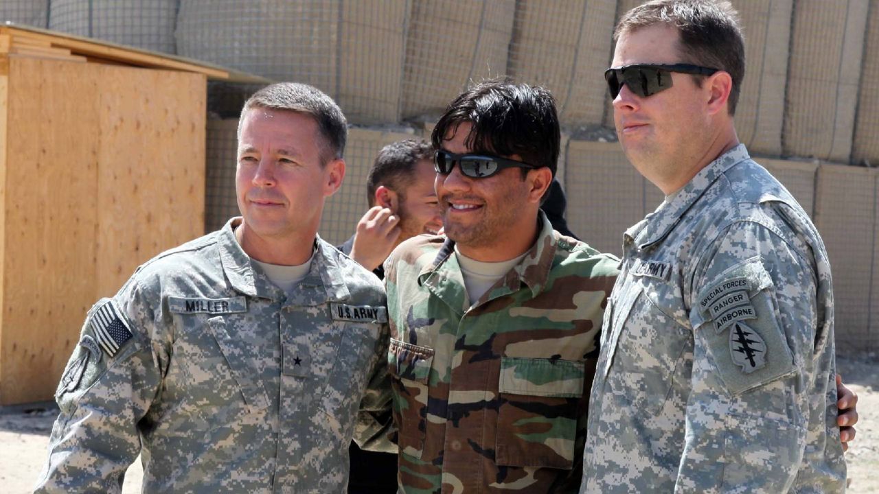 A U.S. general poses for a photo with an Afghan interpreter during a command visit on Tuesday, April 6, 2010. (Courtesy Department of Defense)
