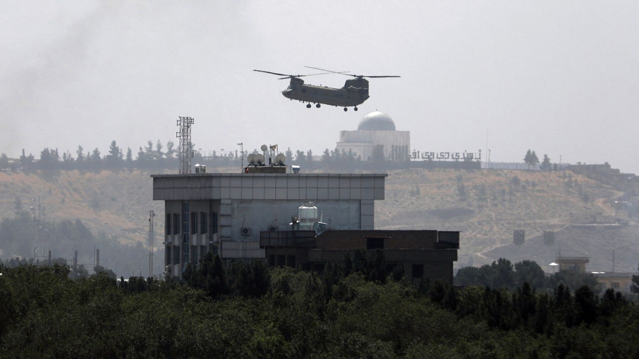 A U.S. Chinook helicopter flies over the U.S. Embassy in Kabul, Afghanistan, Sunday, Aug. 15, 2021. Helicopters landed at the U.S. Embassy in Kabul as diplomatic vehicles left the compound amid the Taliban advance on the Afghan capital. (AP/Rahmat Gul)
