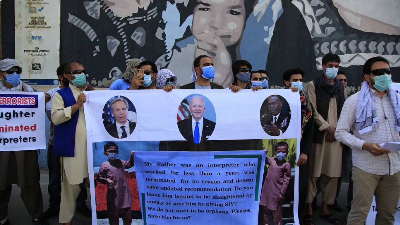 Former Afghan interpreters hold placards during a demonstrations against the US government, in front of the US Embassy in Kabul, Afghanistan, Friday, June 25, 2021. They called for officials to broaden the scope of who is eligible for protection under a US visa. (AP Photo/Mariam Zuhaib)
