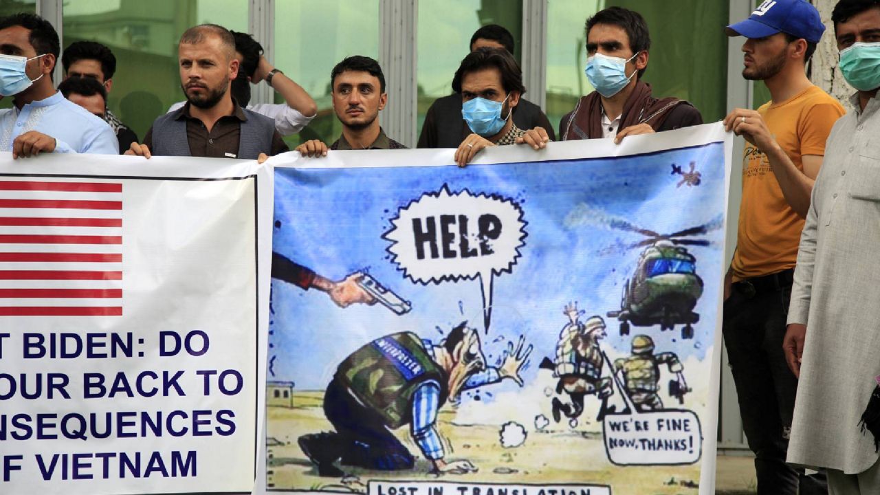 FILE - In this Friday, April 30, 2021, file photo former Afghan interpreters hold banners during a protest against the U.S. government and NATO in Kabul, Afghanistan. (AP Photo/Mariam Zuhaib,File)