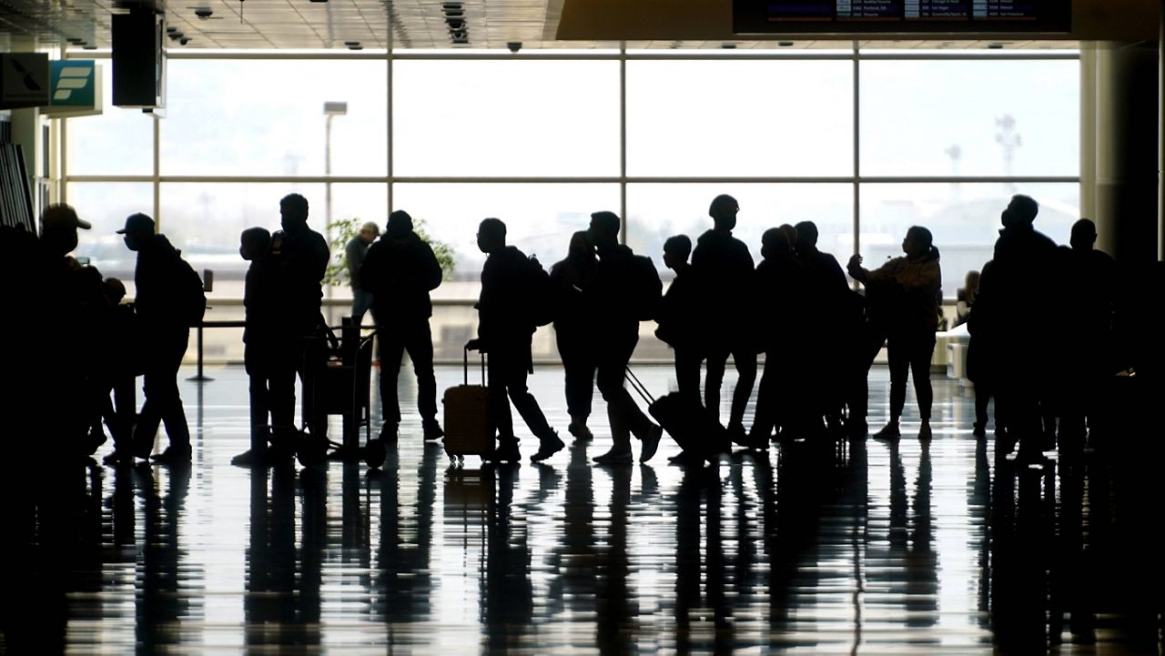 Travelers walk through the Salt Lake City International Airport in Utah on Wednesday. (AP Photo/Rick Bowmer, file)