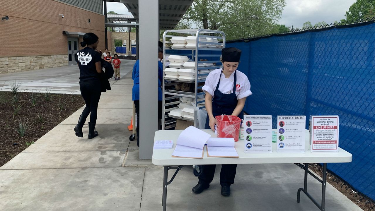 Govalle Elementary School staff in Austin prepare to give out free lunches to students. (Spectrum News)