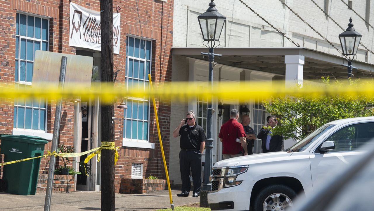 Law enforcement investigates a mass shooting Sunday at Mahogany Masterpiece dance studio in Dadeville , Ala. (Jake Crandall/The Montgomery Advertiser via AP)