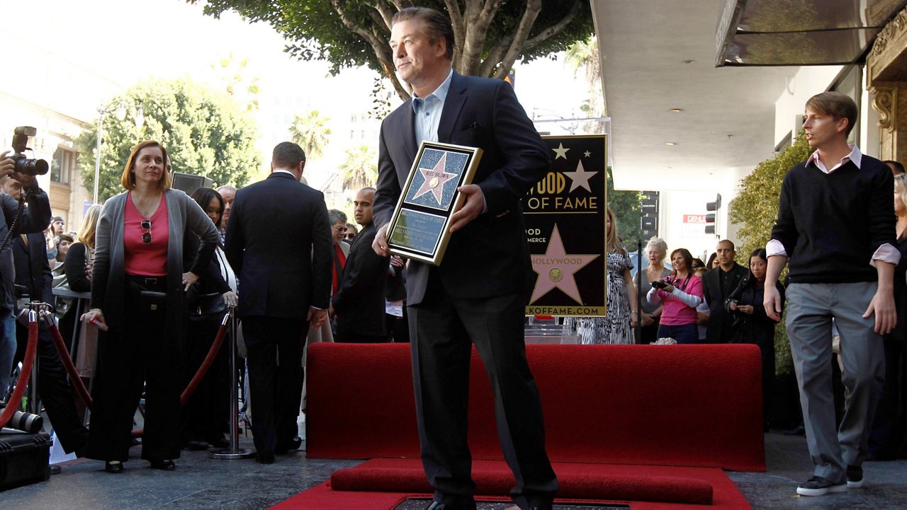 Alec Baldwin poses after he received a star on the Hollywood Walk of Fame in Los Angeles on Feb. 14, 2011. Baldwin is going on trial for involuntary manslaughter after nearly 35 years in the public eye. (AP Photo/Matt Sayles)