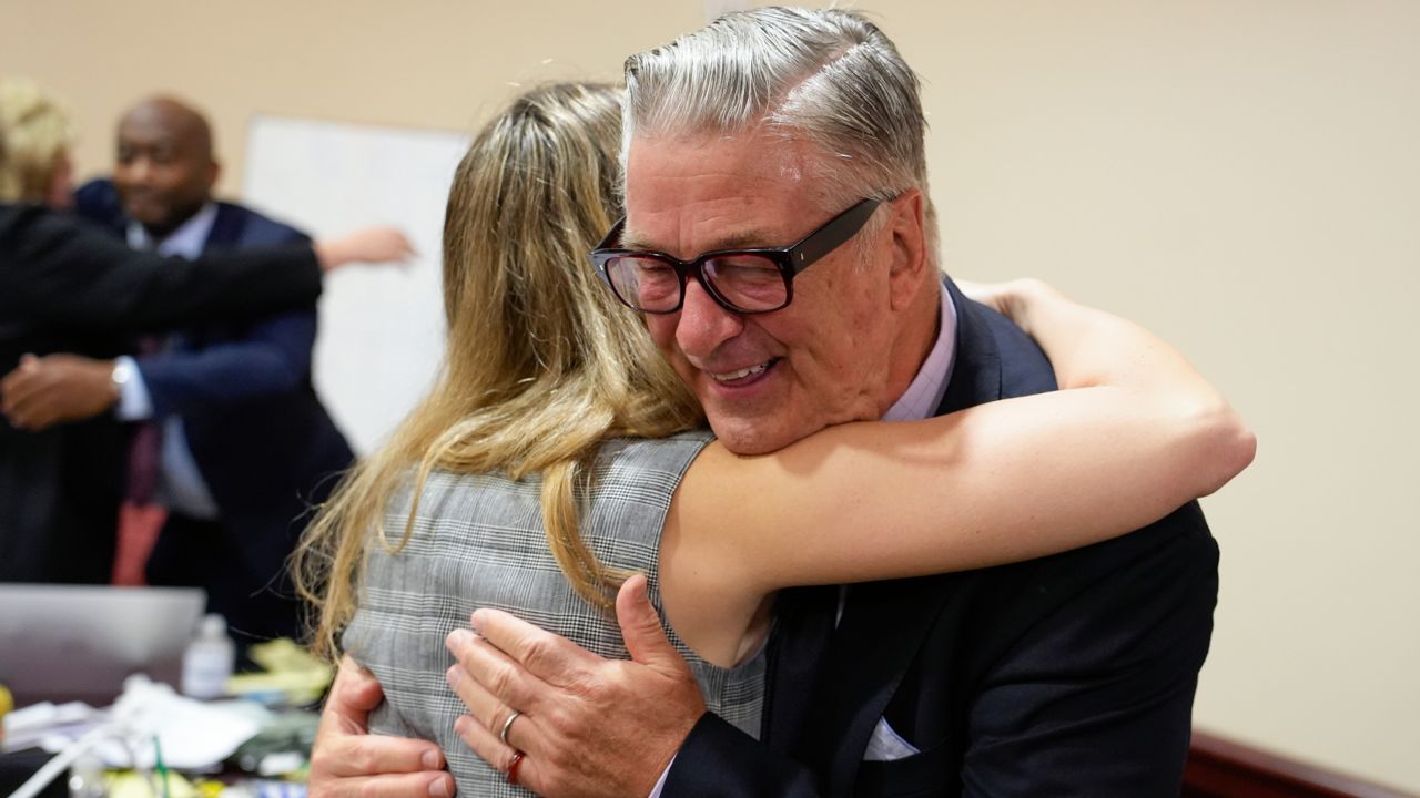 Actor Alec Baldwin hugs a member of his legal team after the judge threw out the involuntary manslaughter case for the 2021 fatal shooting of cinematographer Halyna Hutchins during filming of the Western movie "Rust," July 12, 2024, in Santa Fe, N.M. (Ramsay de Give/Pool Photo via AP)