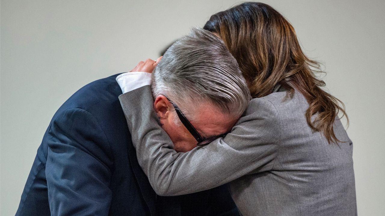 Actor Alec Baldwin, left, reacts as his wife Hilaria hugs him during a break in his trial for involuntary manslaughter for the 2021 fatal shooting of cinematographer Halyna Hutchins during filming of the Western movie "Rust," July 12, 2024, at Santa Fe County District Court in Santa Fe, N.M. (Eddie Moore/The Albuquerque Journal via AP, Pool)