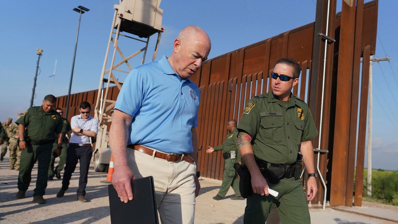 Homeland Security Secretary Alejandro Mayorkas, left, listens to Deputy patrol agent in charge of the US Border Patrol Anthony Crane as he tours the section of the border wall Tuesday, May 17, 2022, in Hidalgo, Texas. (Joel Martinez/The Monitor via AP, Pool)