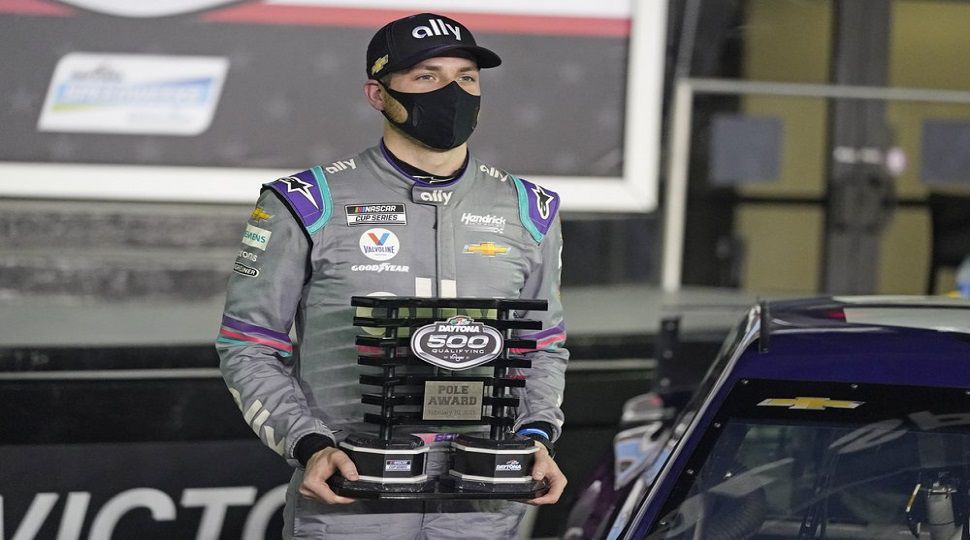 Alex Bowman holds the Pole Award Trophy in Victory Lane after winning the pole for the NASCAR Daytona 500 auto race at Daytona International Speedway, Wednesday, Feb. 10, 2021, in Daytona Beach, Fla. (AP Photo/John Raoux)