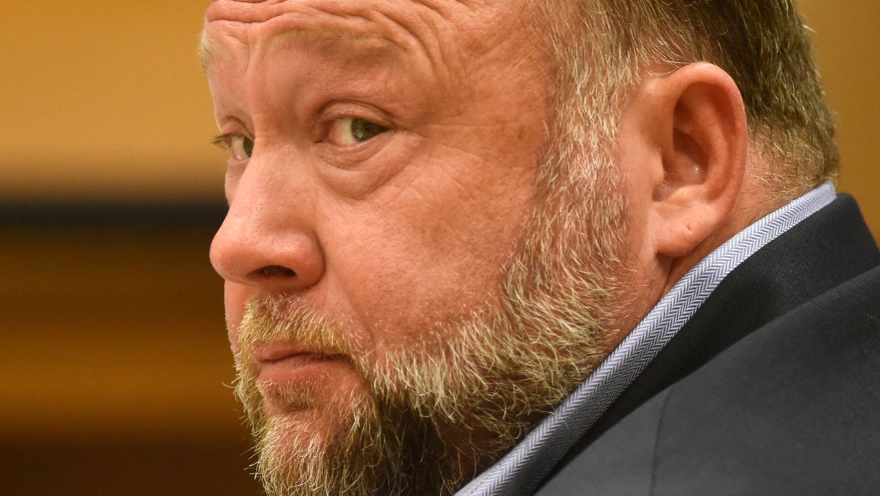 Infowars founder Alex Jones appears in court to testify during the Sandy Hook defamation damages trial at Connecticut Superior Court, Sept. 22, 2022, in Waterbury, Conn. Sandy Hook families who won nearly $1.5 billion in legal judgments against conspiracy theorist Jones for calling the 2012 Connecticut school shooting a hoax have offered to settle that debt for only pennies on the dollar — at least $85 million over 10 years. (Tyler Sizemore/Hearst Connecticut Media via AP, Pool, File)