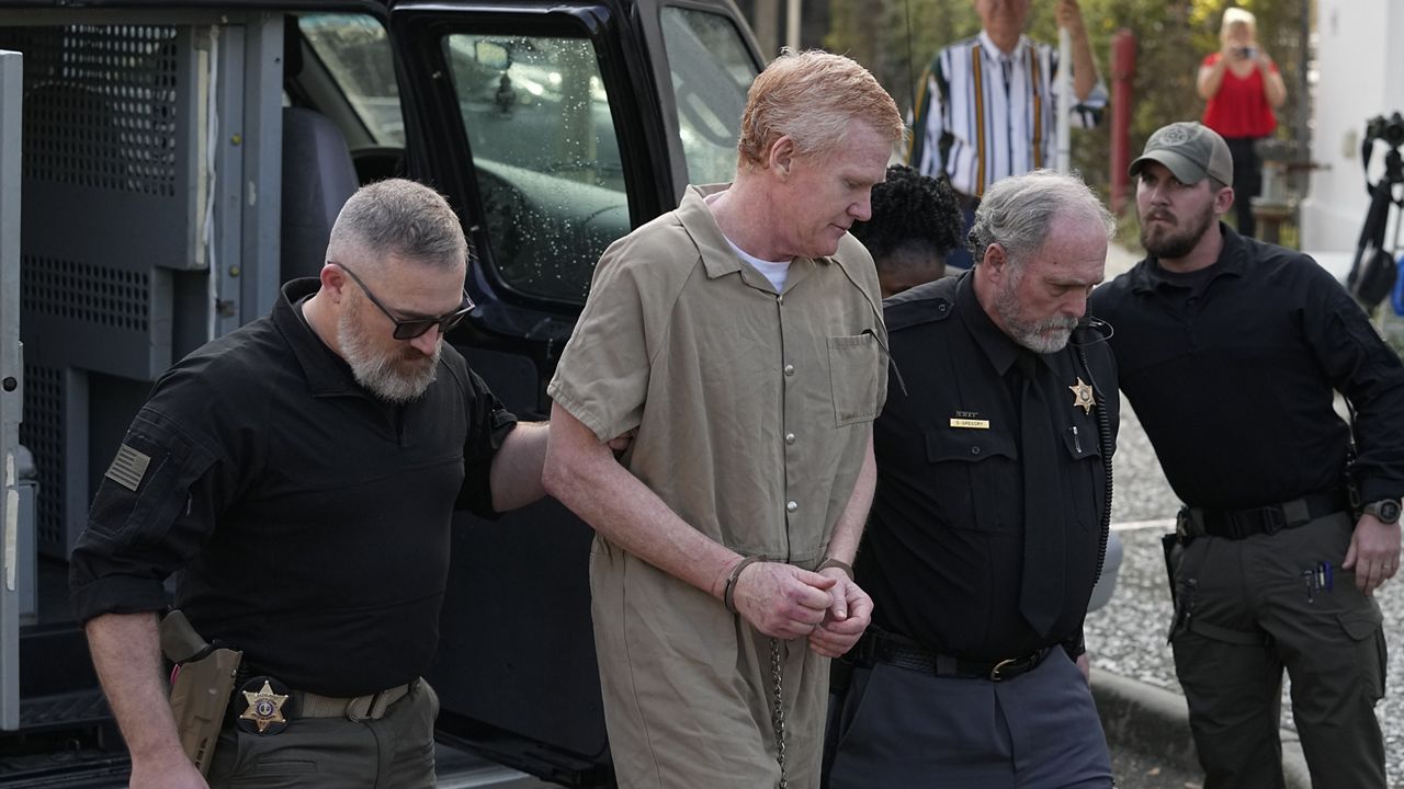 Alex Murdaugh is led to the Colleton County Courthouse by sheriff's deputies for sentencing Friday in Walterboro, S.C.. (AP Photo/Chris Carlson)