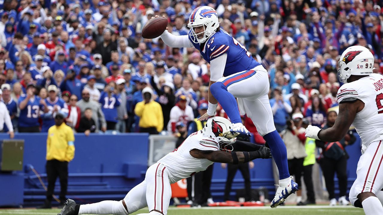 Buffalo Bills quarterback Josh Allen (17) leaps over Arizona Cardinals safety Budda Baker for a touchdown during the second half of an NFL football game Sunday, Sept. 8, 2024, in Orchard Park, N.Y. (AP Photo/Jeffrey T. Barnes)