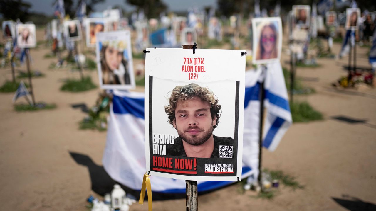 A poster depicting Israeli hostage Alon Ohel is displayed in Re'im, southern Israel at the Gaza border, Monday, Feb. 26, 2024 at a memorial site for the Nova music festival site where he was kidnapped to Gaza by Hamas on Oct. 7, 2023. (AP Photo/Maya Alleruzzo, File)