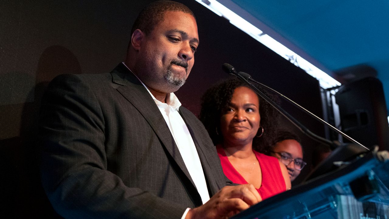 Alvin Bragg became emotional several times while speaking beside his family at an primary night party for supporters in Harlem, June 22, 2021. (AP Photo/Craig Ruttle)