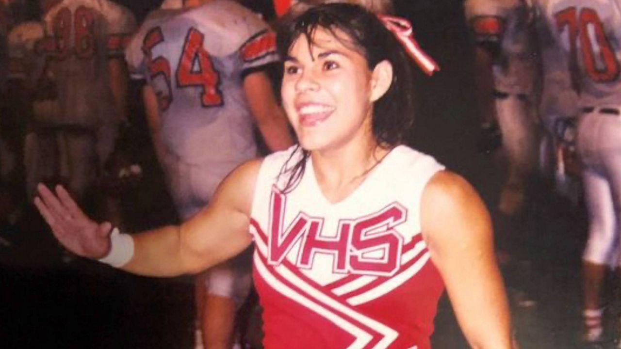 Pictured is Amanda Johnson in her Victoria High School cheer uniform. Johnson was a standout cheerleader whose high school cheer team achieved national success. (Credit, Kelly Perales)