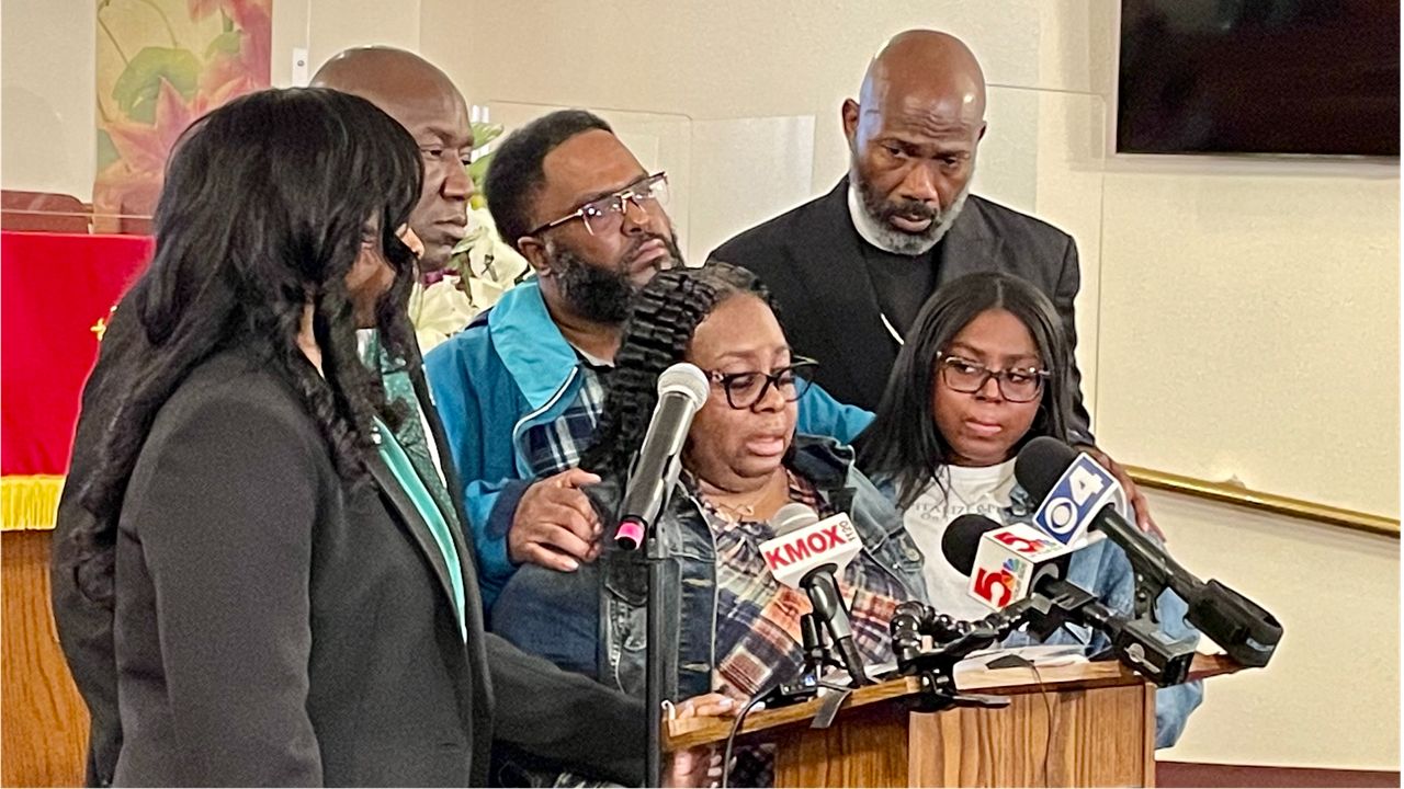 Deon January, center, talks about her son, DeAndre Morrow, who died at the Edwardsville Amazon warehouse 