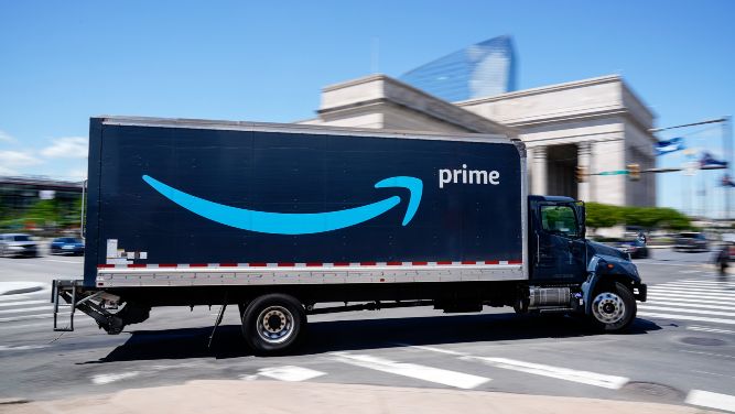An Amazon Prime truck driving across the street. (AP Images)