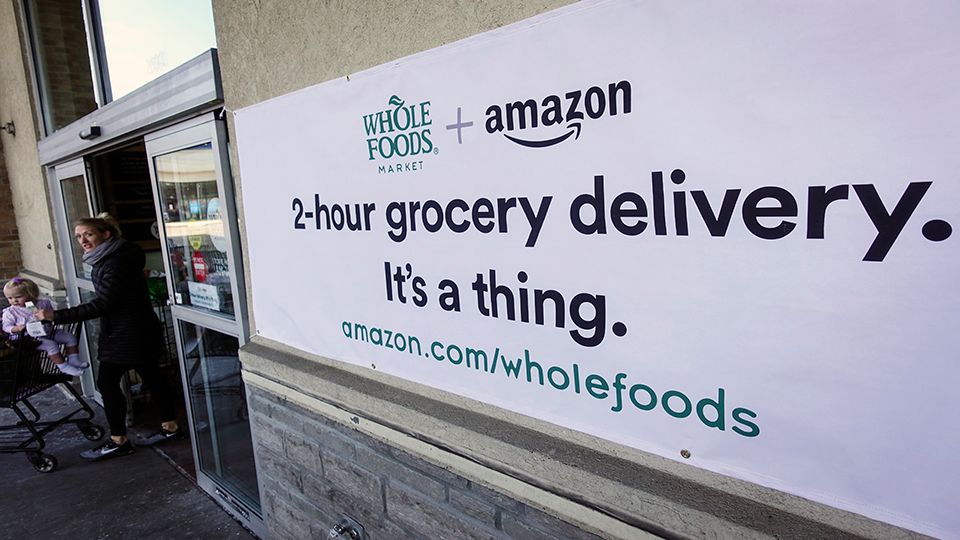 FILE- Advertisement for Amazon delivery from Whole Foods.
