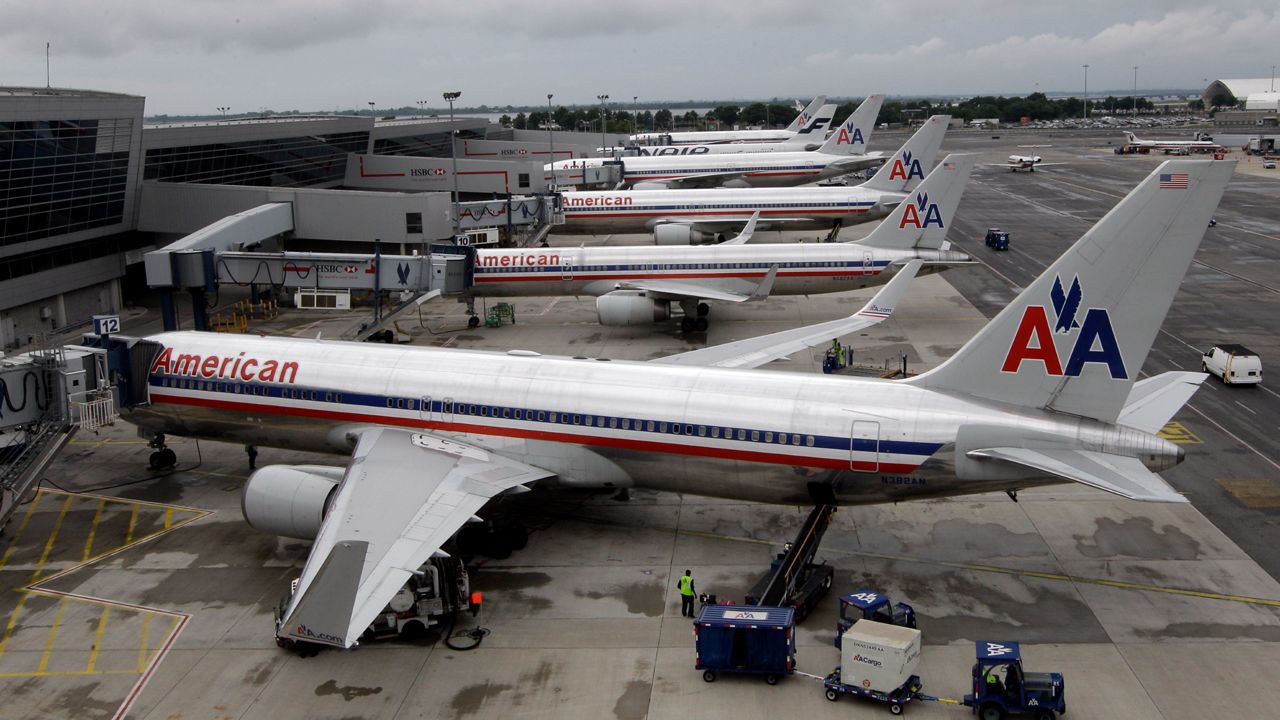 In this Wednesday, Aug. 1 2012 photo, American Airlines airplanes are parked at the gate at JFK International airport in New York. (AP Photo/Mary Altaffer)