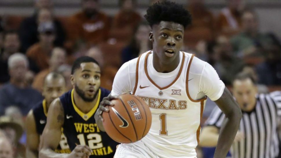 In this Jan. 14, 2017 photo Texas guard Andrew Jones (1) brings the ball up court during the second half of an NCAA college basketball game against West Virginia in Austin, Texas. (AP Photo/Eric Gay)