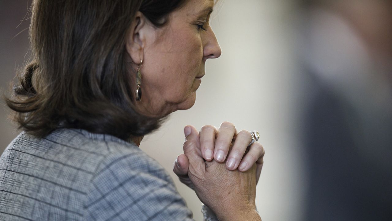 Texas State Sen. Angela Paxton, R-McKinney, wife of suspended Texas state Attorney General Ken Paxton, bows her head in prayer before as her husband's impeachment trial resumes in the Senate Chamber at the Texas Capitol on Friday, Sept. 15, 2023, in Austin, Texas. She will not be eligible to cast a vote in the her husband's impeachment trial. (Sam Owens/The San Antonio Express-News via AP, Pool)