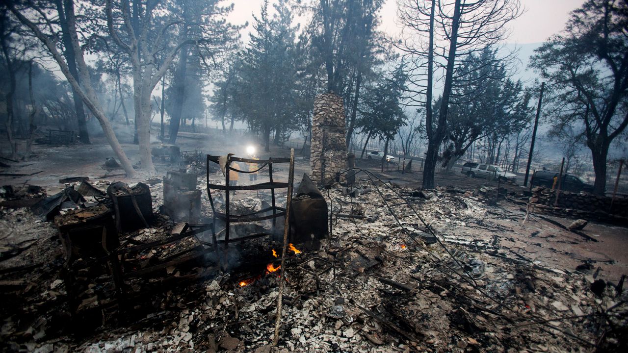 The charred remains of the burned out home are seen in the Lake Hughes fire in Angeles National Forest on Thursday, Aug. 13, 2020, north of Santa Clarita, Calif. (AP Photo/Ringo H.W. Chiu)