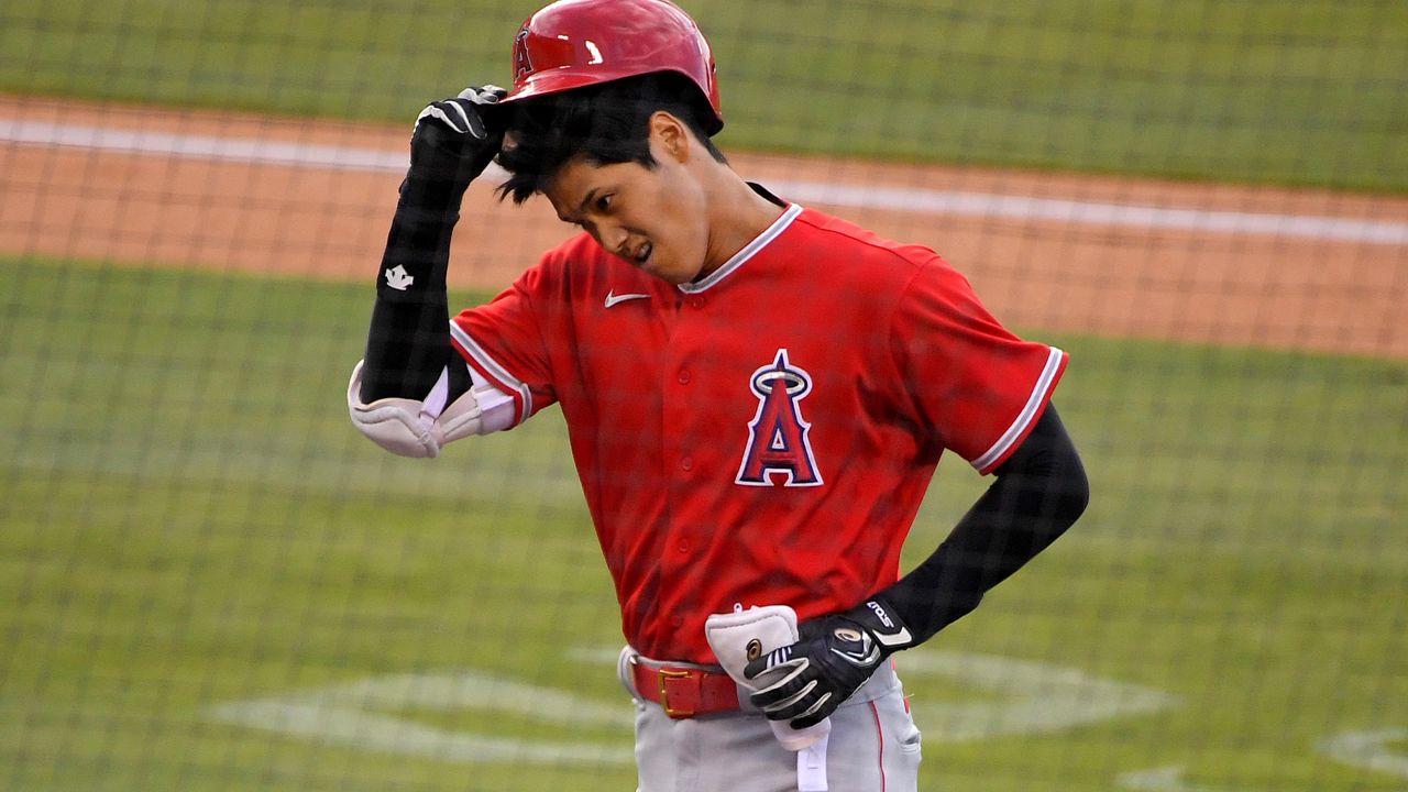 Los Angeles Angels' Shohei Ohtani takes his helmet off after popping out during the first inning of a preseason baseball game against the Los Angeles Dodgers, Tuesday, July 21, 2020, in Los Angeles. (AP Photo/Mark J. Terrill)