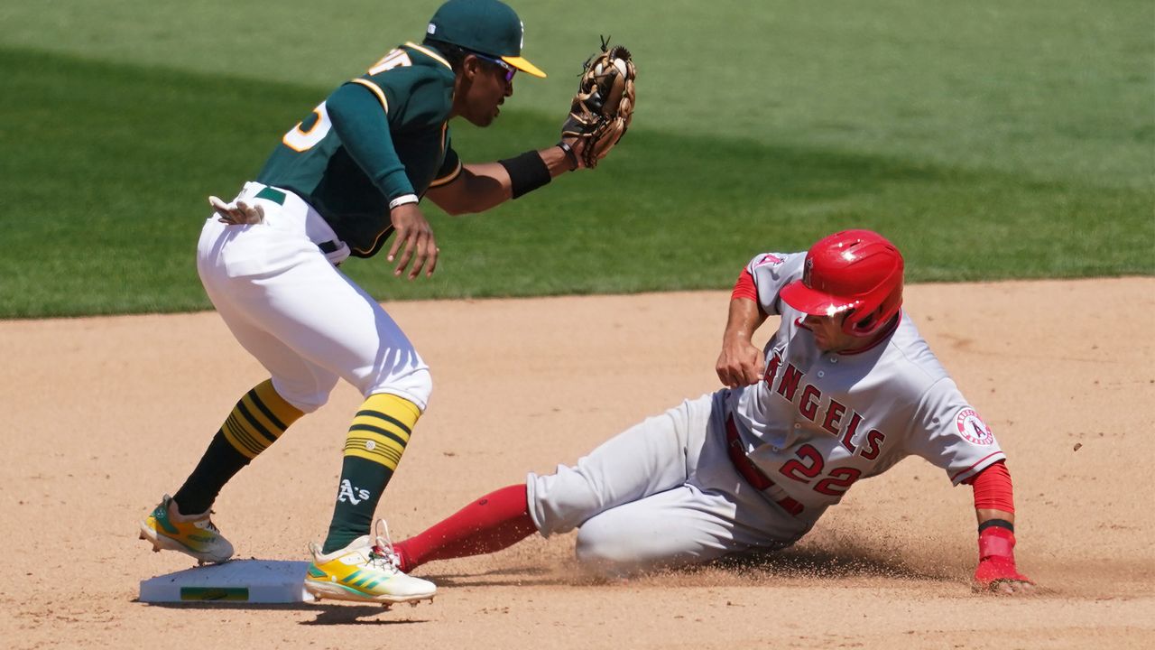 Los Angeles Angels' David Fletcher, right, slides safely into second base next to Oakland Athletics second baseman Tony Kemp with a stolen base during the fifth inning of a baseball game in Oakland, Calif., Sunday, July 26, 2020. (AP Photo/Jeff Chiu)