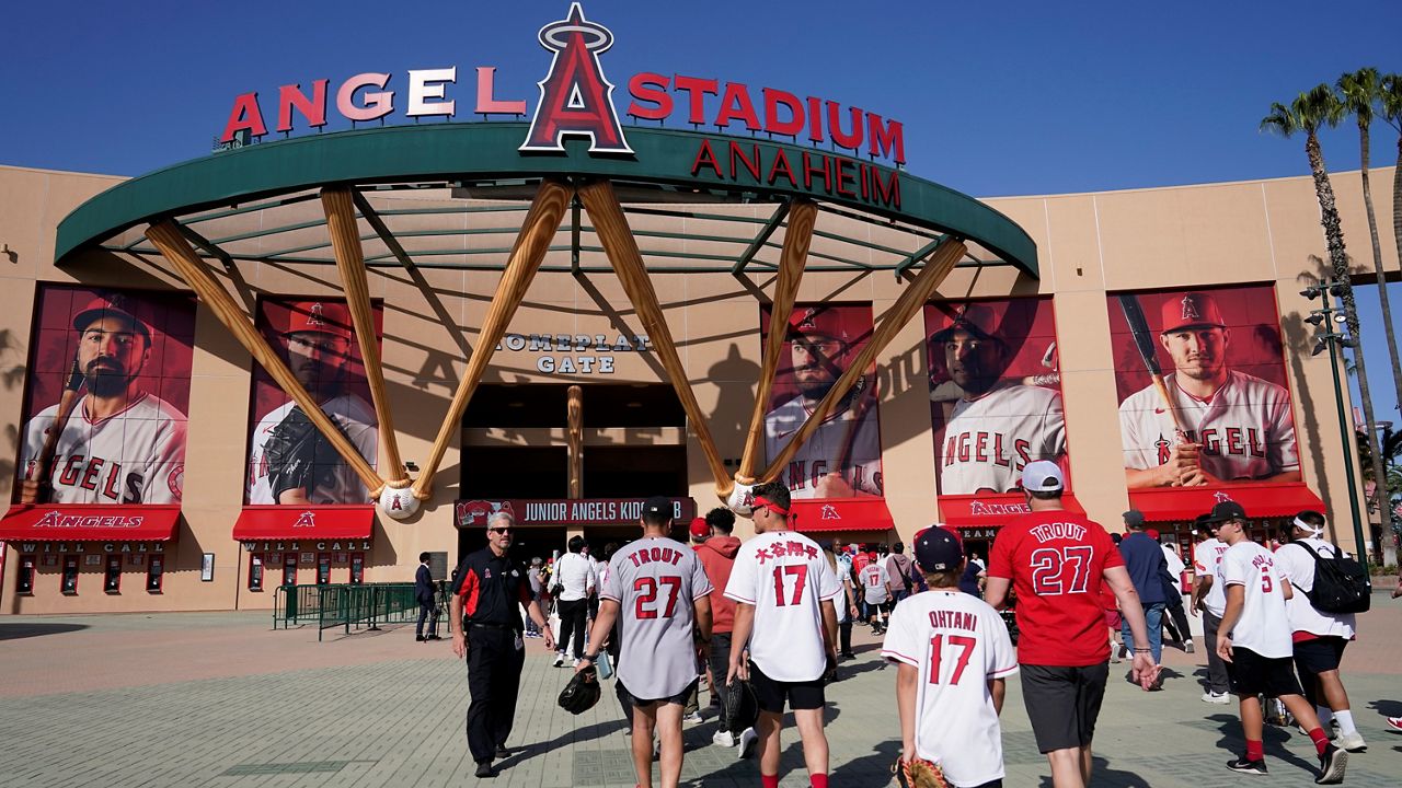 Fans enter Angels Stadium before a baseball game between the Los Angeles Angels and the Houston Astros Thursday, April 7, 2022, in Anaheim, Calif. (AP Photo/Ashley Landis )