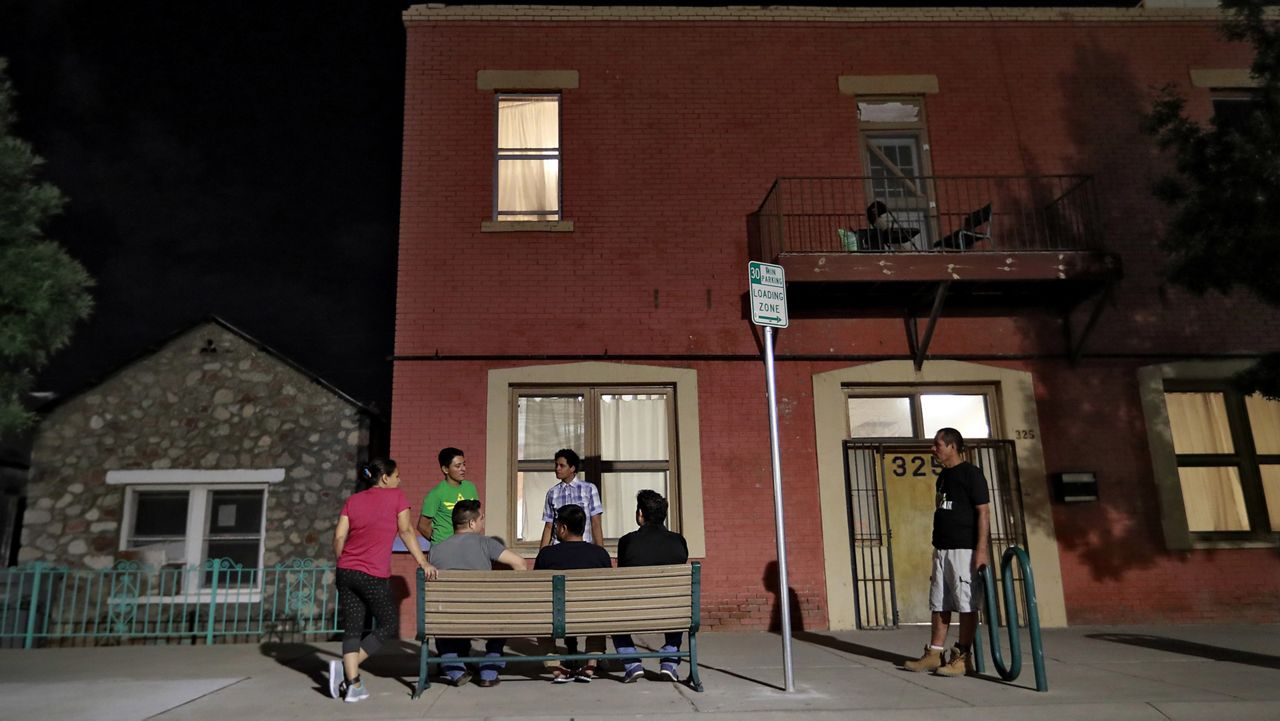 Migrant parents socialize outside the Annunciation House, June 26, 2018, in El Paso, Texas. (AP Photo/Matt York, File)