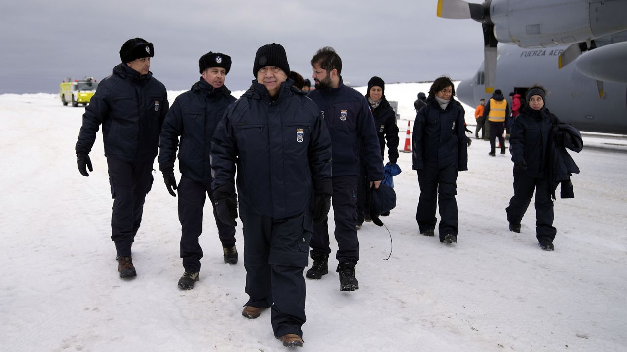  United Nations Secretary-General Antonio Guterres, center, is followed by Chile's President Gabriel Boric, center right, upon their arrival to Chile´s Eduardo Frei Air Force Base at King George Island, South Shetlands, Antarctica, Thursday, Nov. 23, 2023. (AP Photo/Jorge Saenz)