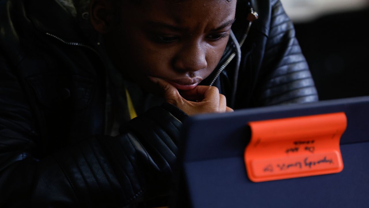 Kynnedy Lewis watches her screen as she prepares for the digital SAT, Wednesday, March 6, 2024, at Holy Family Cristo Rey Catholic High School in Birmingham, Ala.