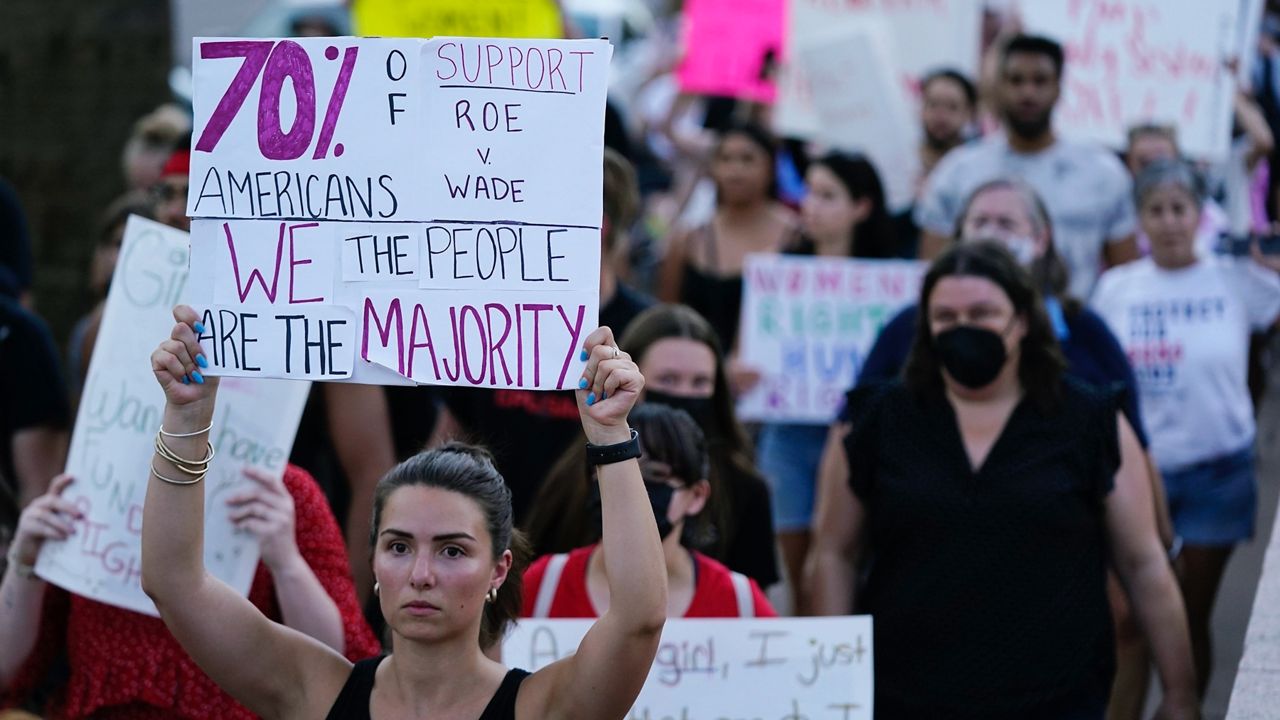 Protesters march around the Arizona Capitol in Phoenix after the Supreme Court decision to overturn Roe v. Wade, Friday, June 24, 2022. (AP Photo/Ross D. Franklin, File)