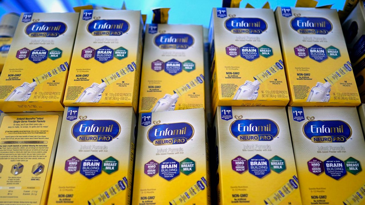 Infant formula is stacked on a table during a baby formula drive to help with the shortage May 14, 2022, in Houston. (AP Photo/David J. Phillip, File)
