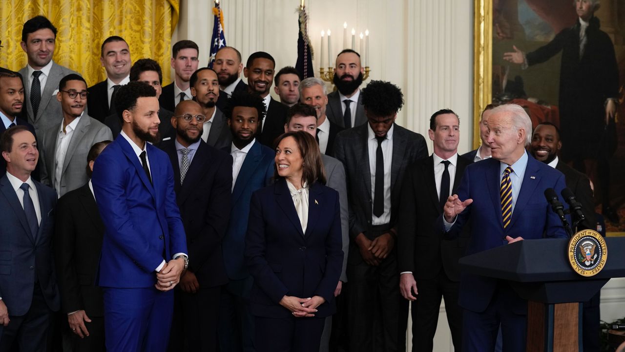 President Joe Biden and Vice President Kamala Harris look to Stephen Curry as they welcome the 2022 NBA champions, the Golden State Warriors, to the East Room of the White House in Washington, Tuesday, Jan 17, 2023. (AP Photo/Susan Walsh)