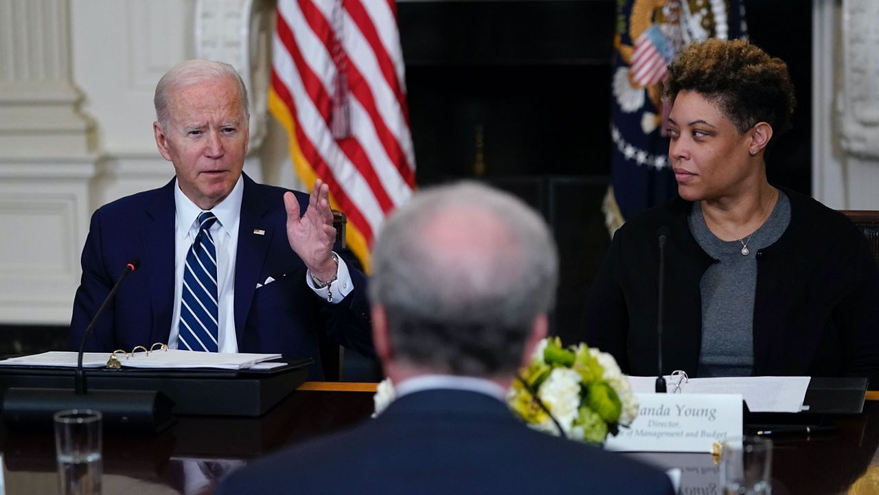 President Joe Biden, left, sitting with Office of Management and Budget Director Shalanda Young, right, and Michael Horowitz, inspector general for the Department of Justice, center, speaks during a meeting with Inspectors General in the State Dining Room of the White House in Washington, Friday, April 29, 2022. (AP Photo/Susan Walsh)