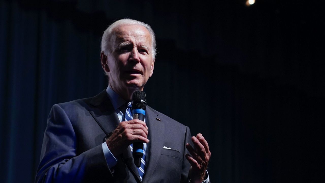 President Joe Biden speaks to a crowd in a overflow room at a rally hosted by the Democratic National Committee at Richard Montgomery High School, Thursday, Aug. 25, 2022, in Rockville, Md. (AP Photo/Evan Vucci)