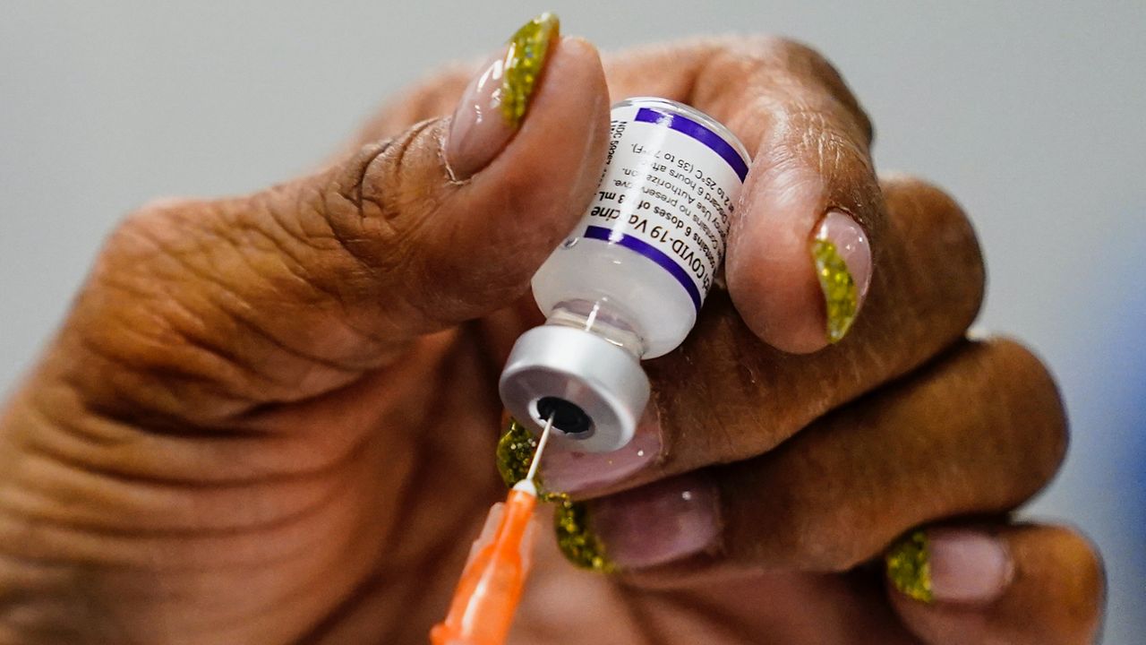 A syringe is prepared with the Pfizer COVID-19 vaccine at a vaccination clinic at the Keystone First Wellness Center in Chester, Pa., Wednesday, Dec. 15, 2021. (AP Photo/Matt Rourke