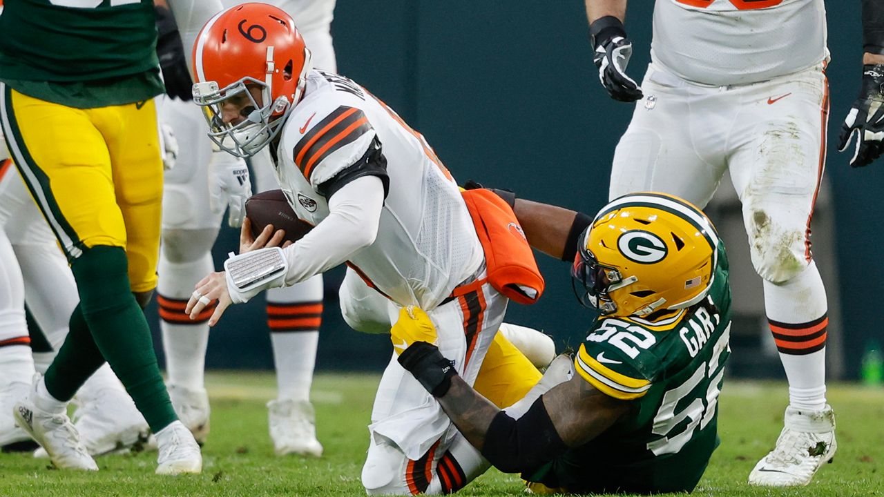 Green Bay Packers outside linebacker Rashan Gary (52) sacks Cleveland Browns quarterback Baker Mayfield (6) during an NFL football game Saturday, Dec 25. 2021, in Green Bay, Wis. (AP Photo/Jeffrey Phelps)