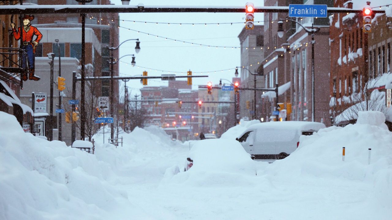 In this photo provided by the Twitter page of New York Gov. Kathy Hochul, snow from this weekend's blizzard covers downtown Buffalo on Monday, Dec. 26, 2022.