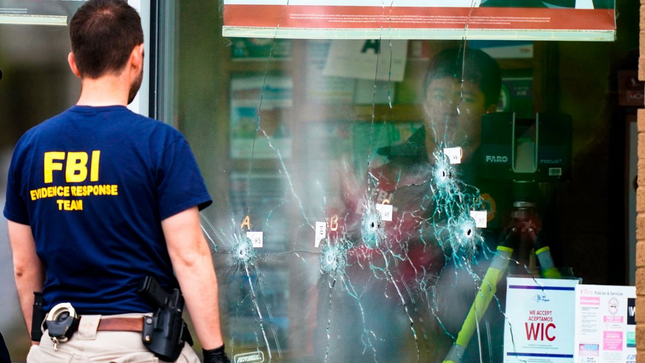 Investigators work the scene of a shooting at a supermarket in Buffalo, N.Y., on May 16. (AP Photo/Matt Rourke)