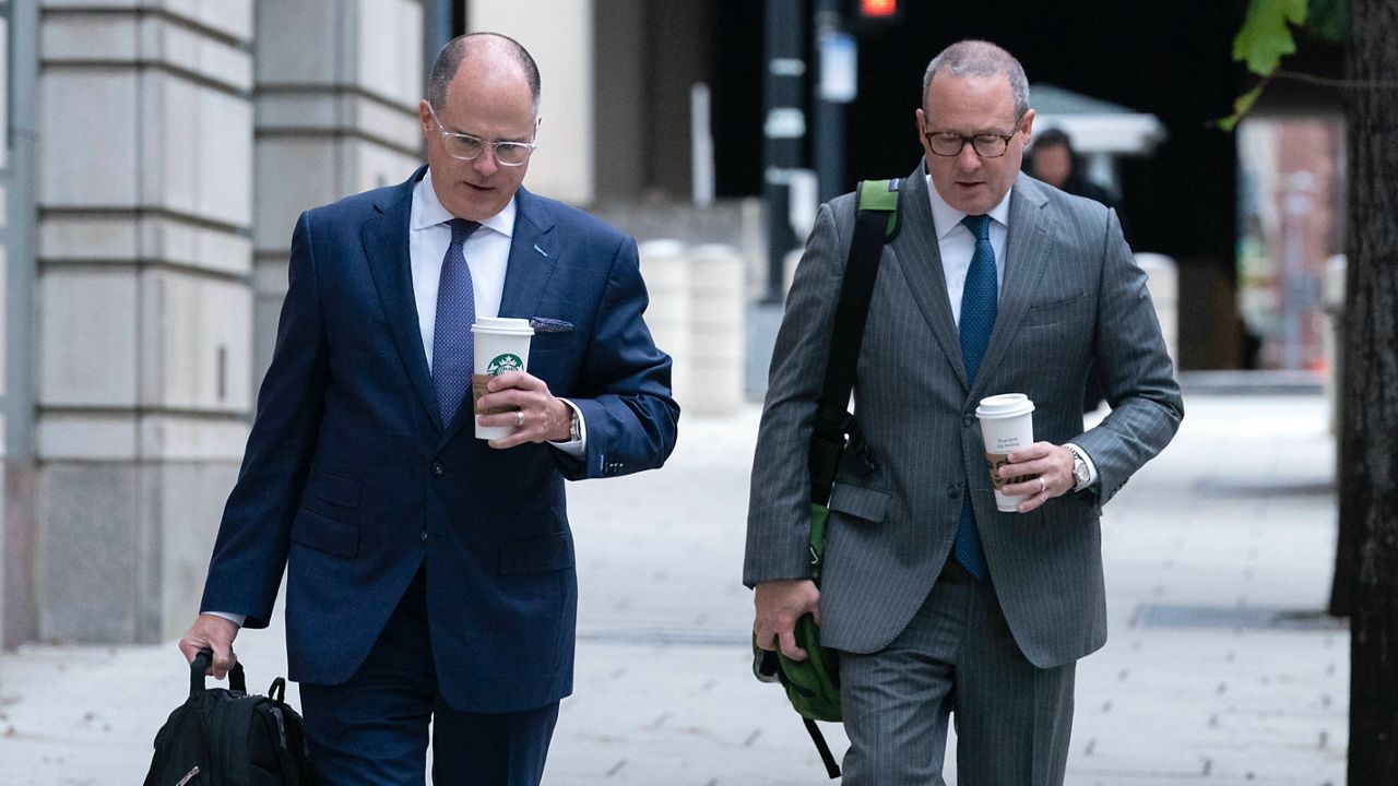 Attorneys of Oath Keepers leader Stewart Rhodes, Phillip Linder, left, and James Lee Bright, arrive at the Federal Courthouse during the Rhodes trial in Washington, Tuesday, Oct. 4, 2022. ( AP Photo/Jose Luis Magana)